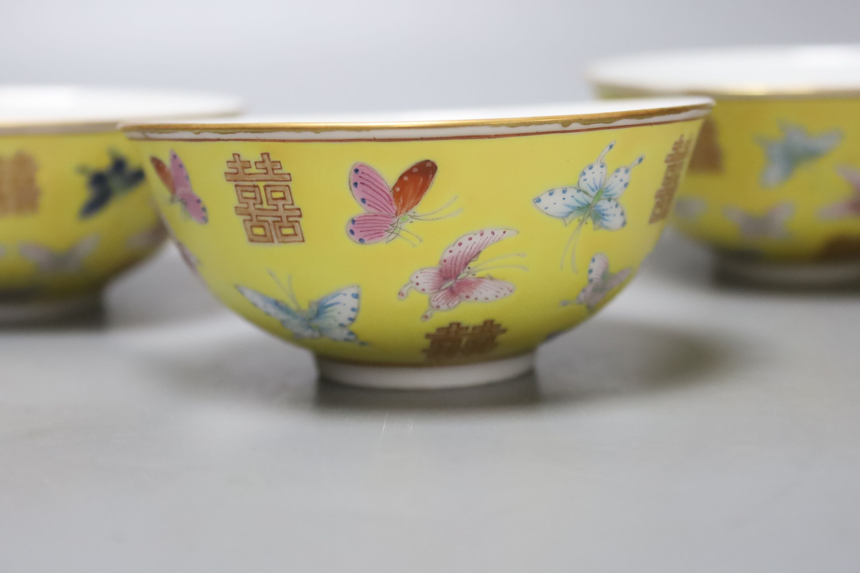 A set of four Chinese yellow ground rice bowls, diameter 11cm